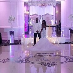 a bride and groom are standing in front of a stage set up for their wedding ceremony