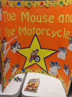 an orange and yellow sign that says the mouse and the motorcycle on it's side