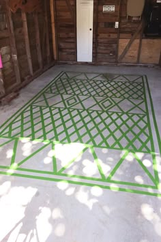 a room with green lines painted on the floor and walls, along with a door