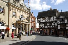 people are walking on the street in front of old buildings