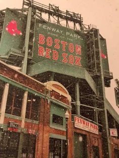 the boston red sox stadium sign is covered in snow