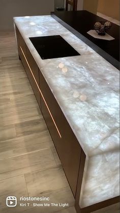 the counter top is shiny and white with some lights shining on it's sides