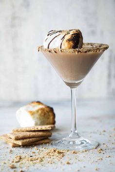 a dessert in a glass next to some crackers