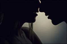 two people kissing each other in front of a dark background with the words, slow me love try every second with you