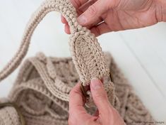 someone is crocheting the end of a sweater