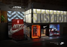 the nike store is lit up at night with neon lights and advertisements on the walls