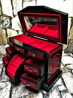 a black and red jewelry box with drawers