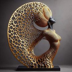 an artistic sculpture made out of gold and black circles with a woman's head in the center