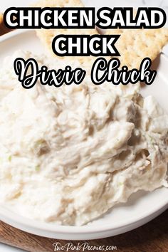 chicken salad is served on a white plate with crackers in the background and text overlay