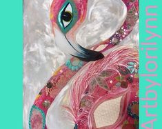 a close up of a pink and white mask with a bird on it's face