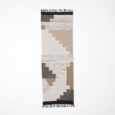 a white and black rug with fringes on it's end, against a white background