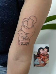 a woman with a tattoo on her arm holding a man's head and hugging him