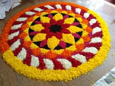 a circular flower arrangement on a wooden table