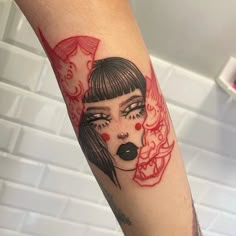 a woman's face with red ink on her arm