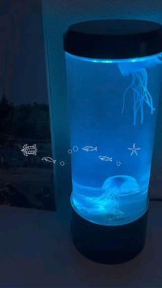 a blue light up glass with an image of jellyfish on it