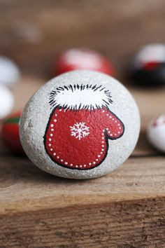 a painted rock with a mitten on it