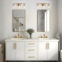 a bathroom with two sinks and mirrors on the wall