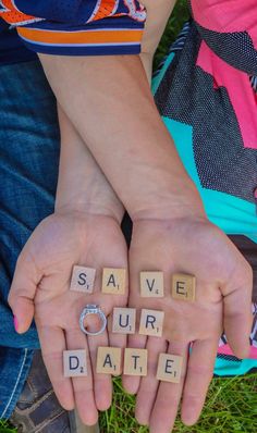 two hands holding scrabble letters spelling save our date