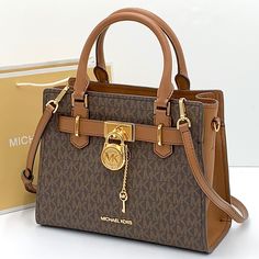 Michael Kors Hamilton Small Satchel Brown/ Luggage Signature Color Michael Kors Hamilton Small Satchel Shoulder Crossbody Bag Michael Kors Logo At Front Zip Top Closure Gold Toned Hardware Mk Key & Lock On Front Custom Mk Fabric Lining 1 Slip-In Pockets 1 Zipper Pocket 10" (L) X 8"(H) X 4"(D) Strap: 4", 18"- 24" Very Clean, Smoke-Free And Pet-Free Environment Crossbody Bag Michael Kors, Brown Luggage, Expensive Purses, Hand Bags For Women, Bag Michael Kors, Michael Kors Logo, Black Leather Satchel, Michael Kors Crossbody Bag, Mk Bags