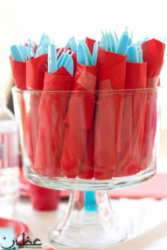 red and blue napkins are in a glass bowl