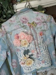 a denim jacket with flowers on the back