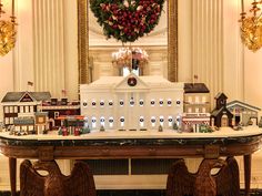 a christmas display in the white house's dining room is decorated with wreaths and holiday decorations