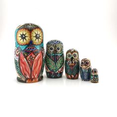 an assortment of colorful owl figurines sitting next to each other