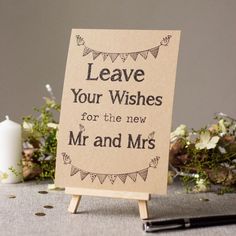 a sign that says leave your wishes for the new mr and mrs on top of a table