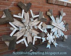 snowflakes made out of wooden planks on the side of a brick building