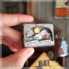 there is a miniature box with some stuff in it that says beyond the sea on it