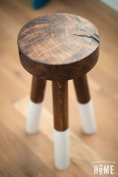 a wooden stool sitting on top of a hard wood floor