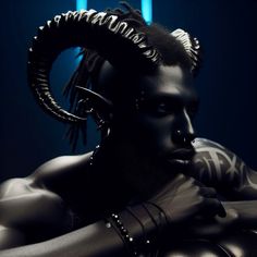 a man with large horns and piercings on his head is posing for a photo