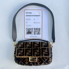 This Fendi Baguette Shoulder Bag Is A Must-Have For Any Fashion-Forward Woman. The Exterior Is Made Of Soft Shearling Fur In A Beautiful Brown Color, Accented With Gold Hardware. The Bag Features A Magnetic Closure And A Leather Handle/Strap In Black, Perfect For Adding A Touch Of Elegance To Any Outfit. The Interior Is Lined With Black Leather And Has Enough Space For All Your Essentials. This Bag Is Perfect For Any Occasion, Whether You're Dressing Up For A Night Out Or Just Running Errands During The Day. The Fendi Zucca Pattern Adds A Unique Touch To This Bag, Making It A True Statement Piece. Things To Note: * In Wonderful Preloved Condition * Small Scratches On Interior Leather * N Brown Baguette Bag, Shoulder Bag Brown, Fendi Baguette, Baguette Bag, Unique Boutique, Magnetic Closure, Leather Handle, Running Errands, Brown Color