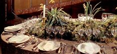 the table is set with silverware and glassware for an elegant dinnereon party