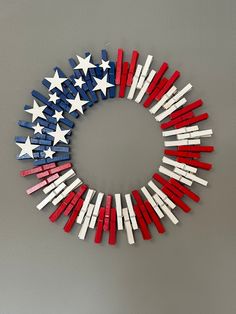 a wreath made out of red, white and blue wooden sticks