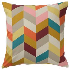 a multicolored chevron pattern pillow on a white background with the word,