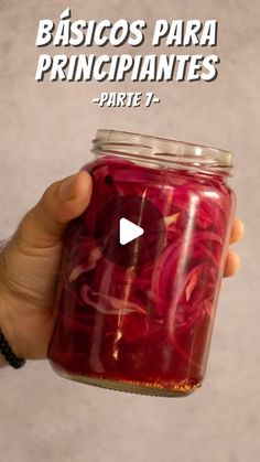 a hand holding a jar filled with pickled red peppers and text reading basicos para principantes parte 7