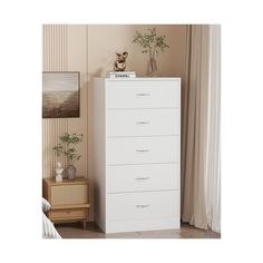 a white chest of drawers in a room