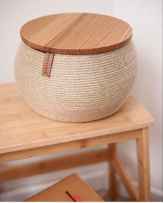 a bowl sitting on top of a wooden table next to a box with a book