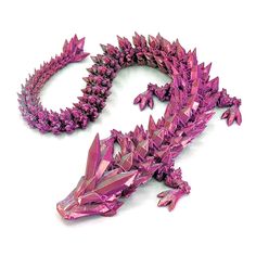 a purple lizard made out of crystals on a white surface with its tail curled up