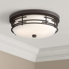 a ceiling light in a room with white walls and trimmings on the ceiling