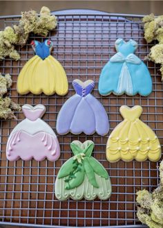 decorated cookies are sitting on a cooling rack