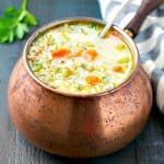 a bowl of soup with carrots, celery and other vegetables in it