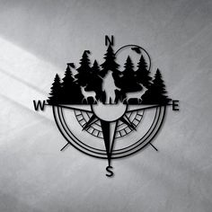 a compass with deer on it and trees in the middle is shown against a white background