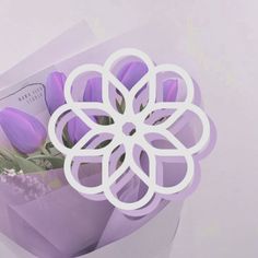 a bouquet of purple tulips in a paper bag