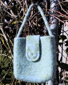 a blue purse hanging from a metal pole