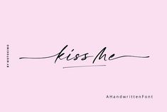 the word kiss me written in cursive handwriting on a pink background