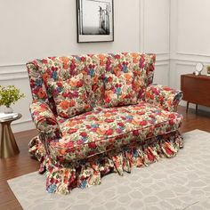 a living room filled with furniture and a rug on top of a hard wood floor