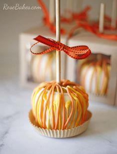 an orange and white striped cake pops on a table