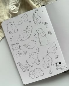 an open notebook with drawings of animals on it